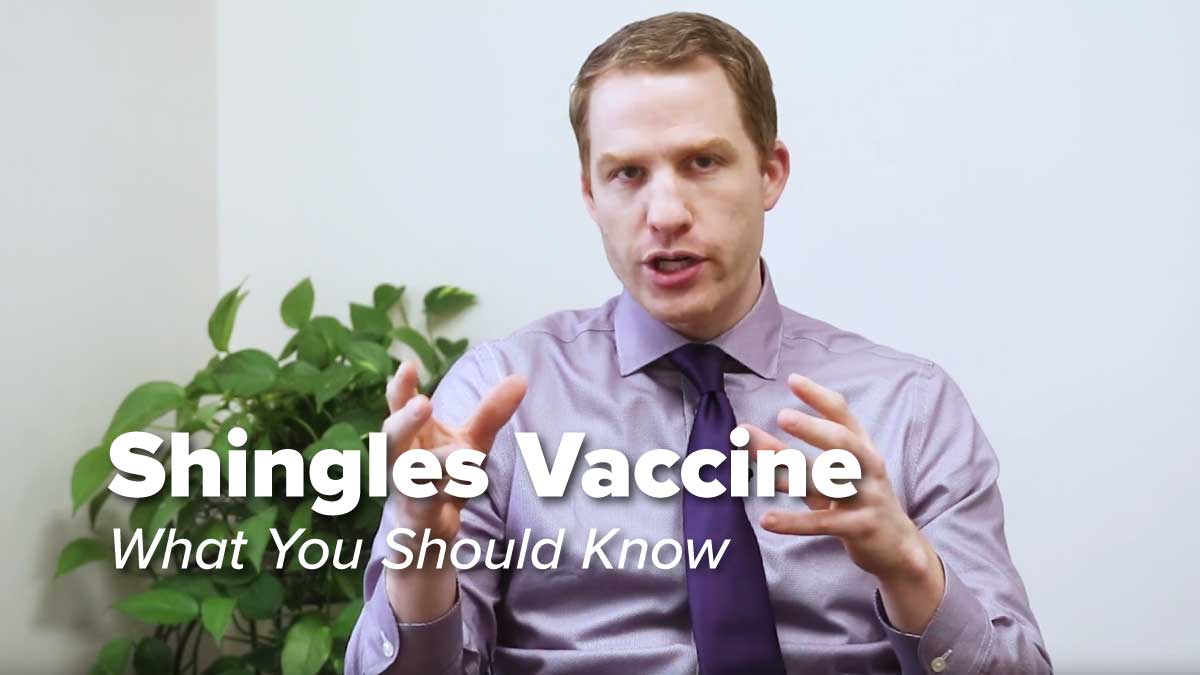 Dr. Chris Mecoli sitting in a chair discussing Shingles Vaccine